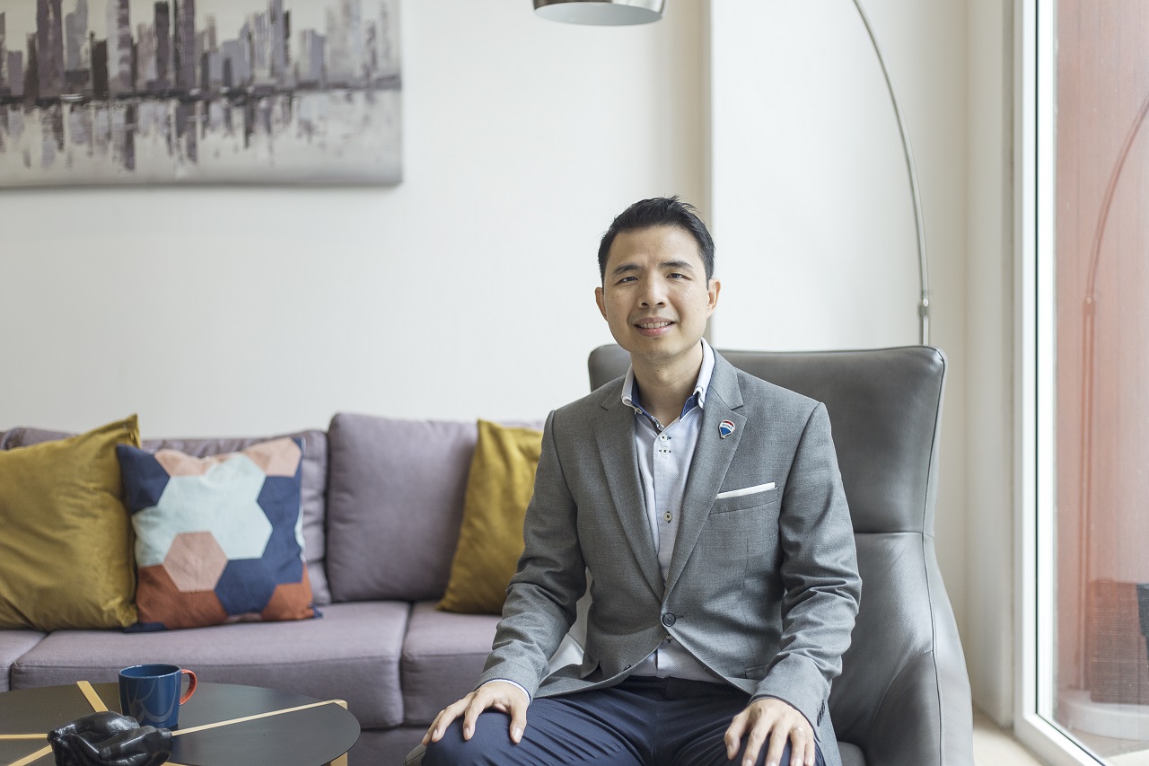 handsome real estate broker sitting on sofa