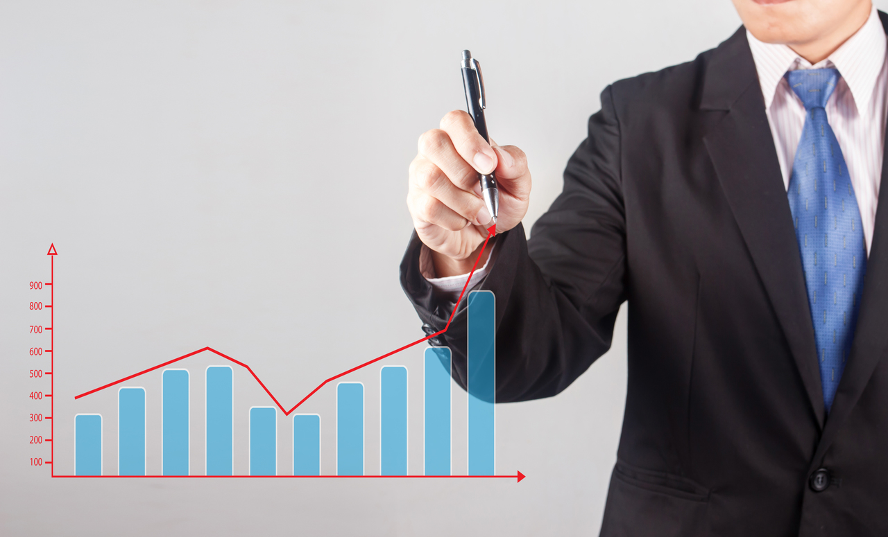 Business man hand drawing a growing graph