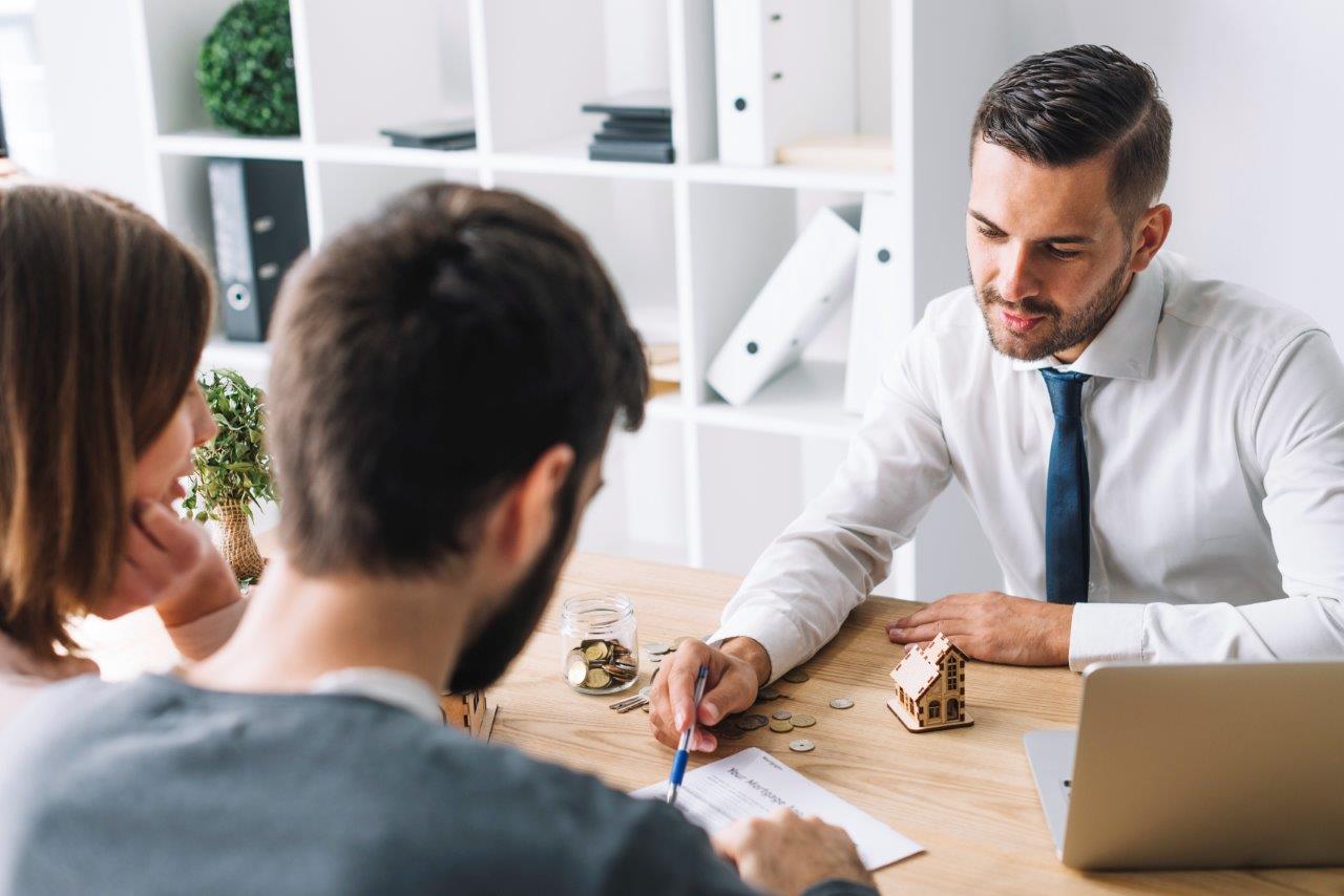 couple talking to real estate broker