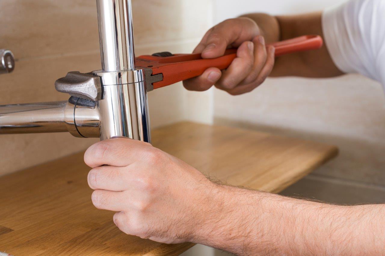 man fixing plumbing