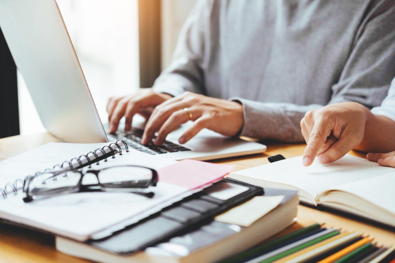 man researching on laptop