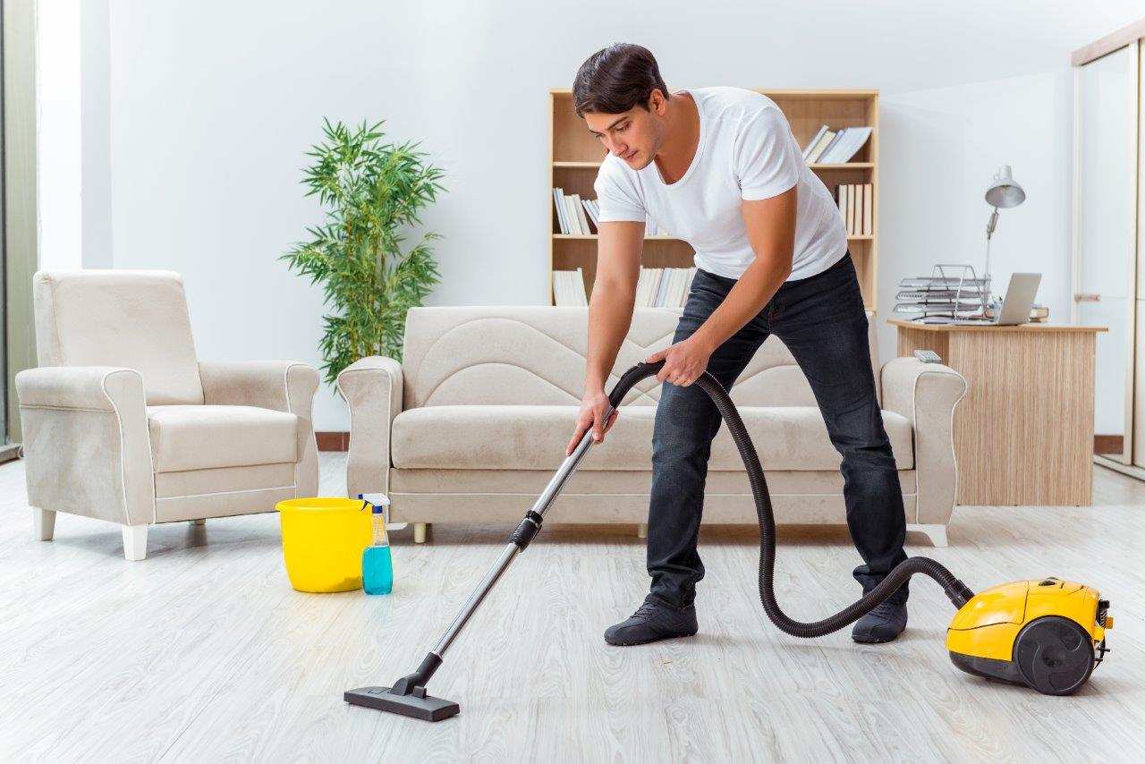 man vacuuming floors