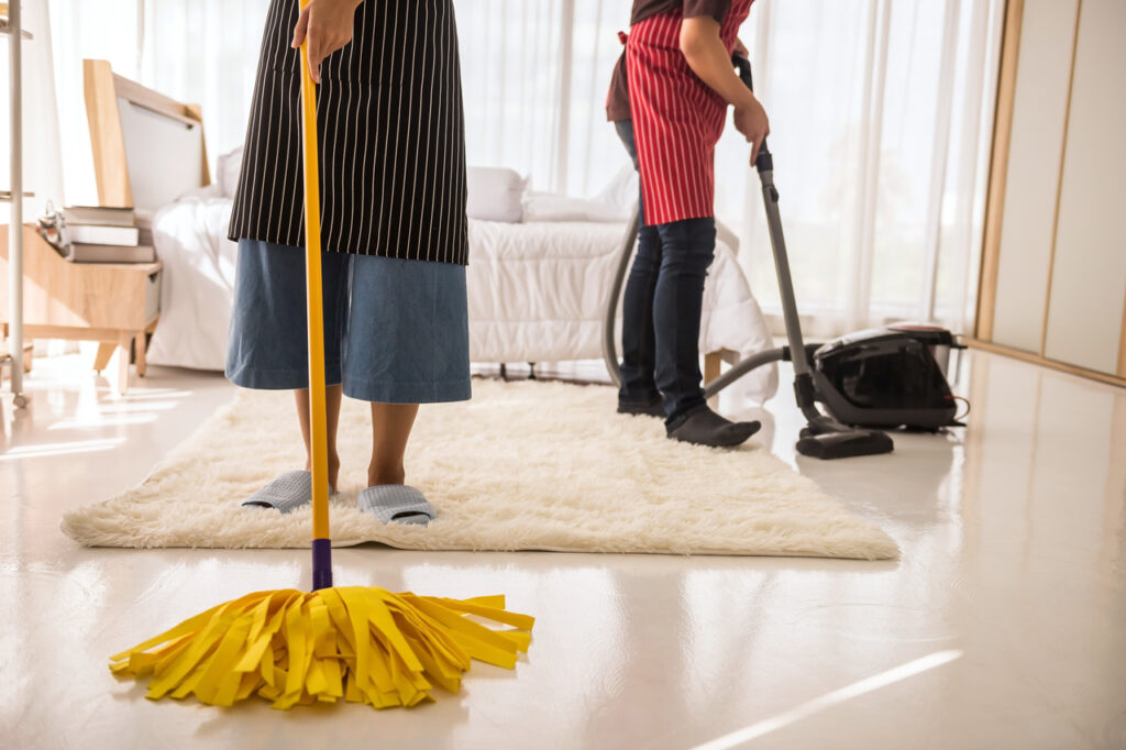 A couple disinfecting their house