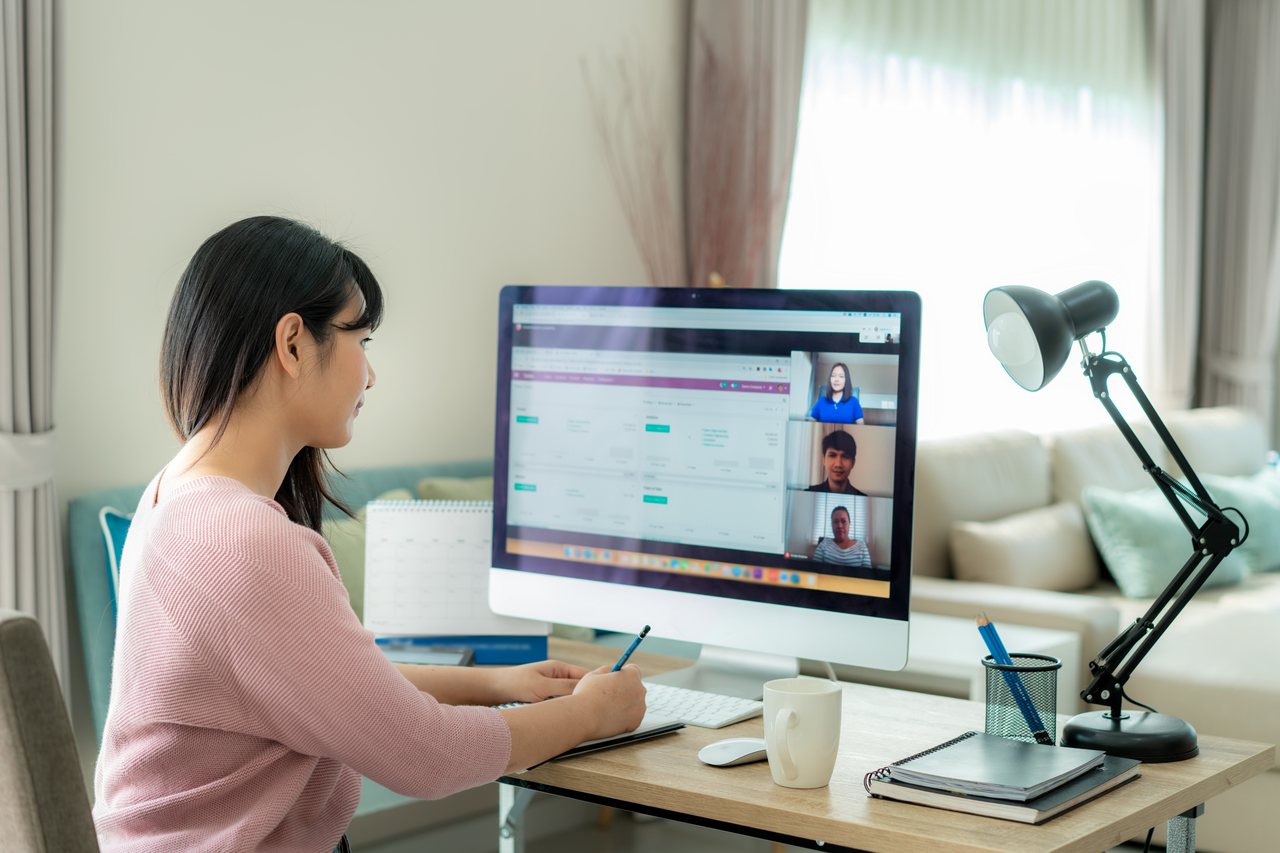 A woman having a virtual meeting in her home office
