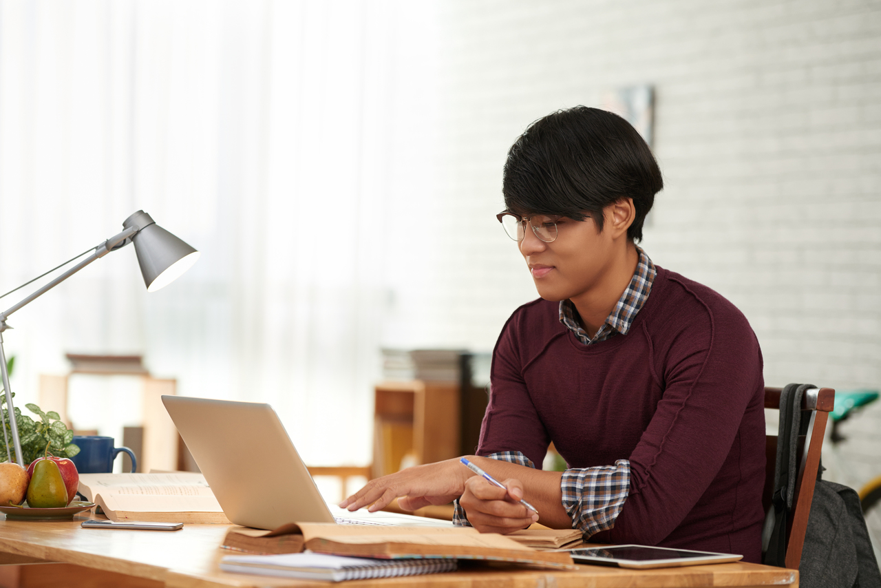 A young businessman working in his home office