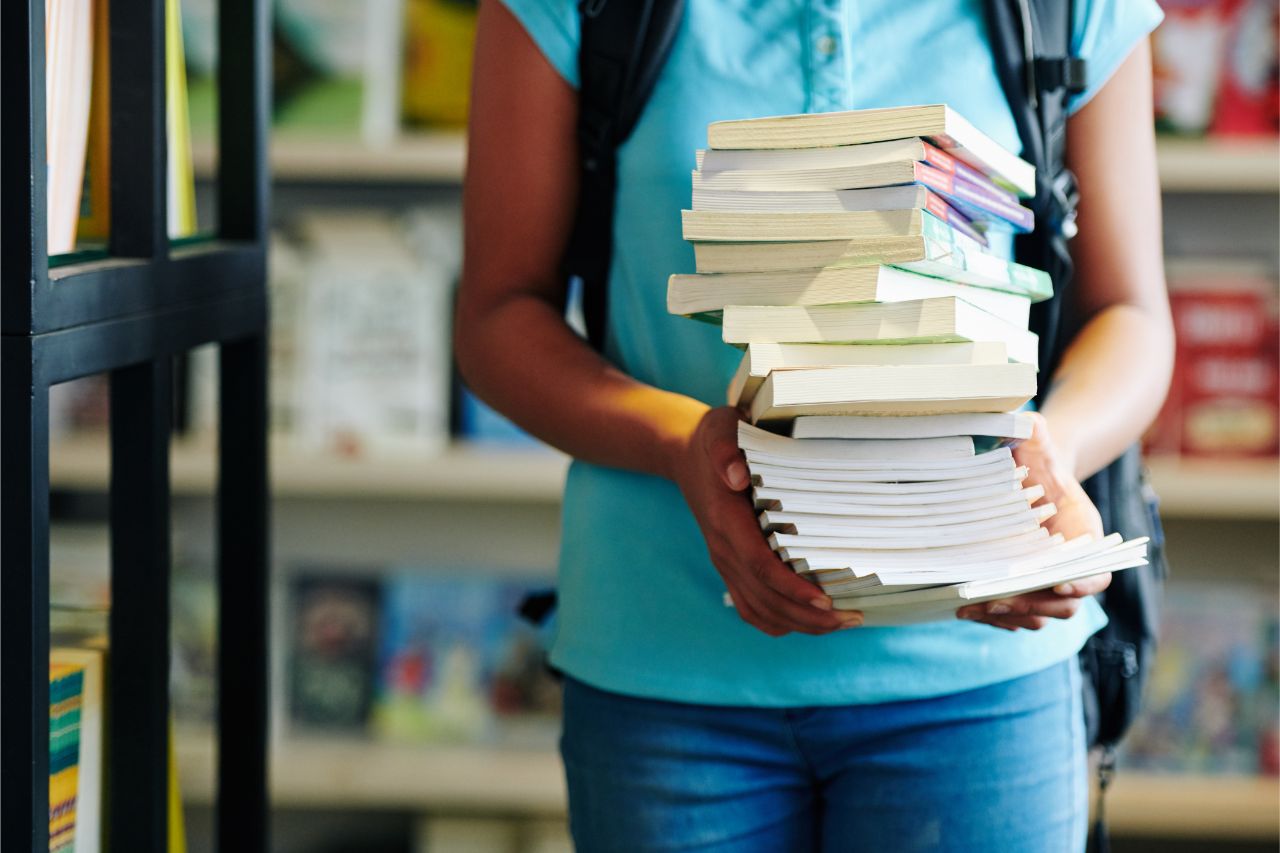 A girl with a stack of books she bought